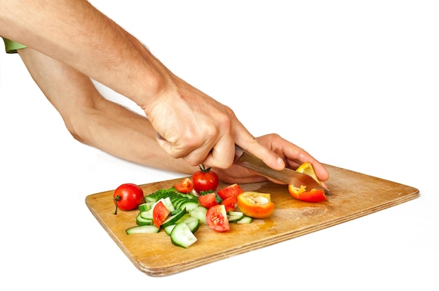 Hands prepare a dish on wooden board